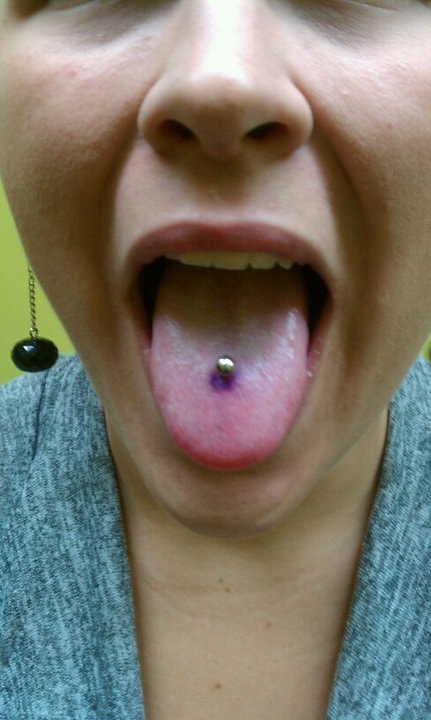 Red gem dermal anchor set in scissors tattoo