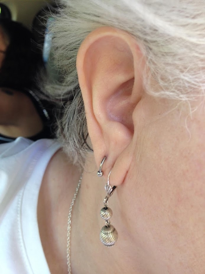Silver drop earring and helix jewelry placement